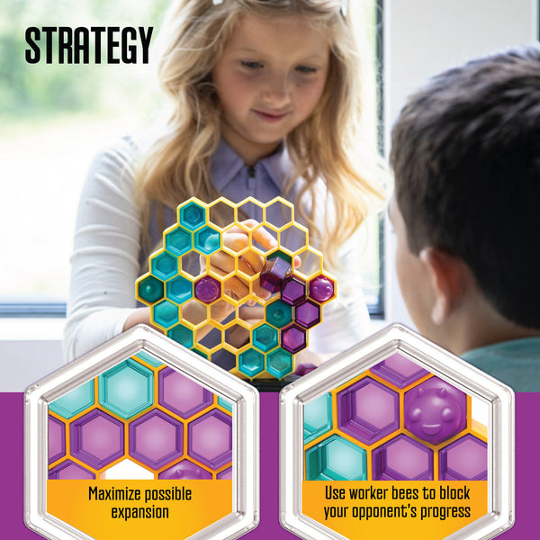 Two children playing with a colorful strategy game involving hexagonal tiles.